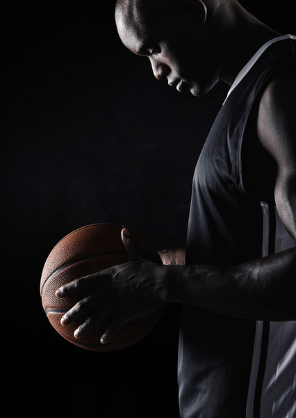 African sportsman holding basketball