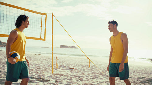 Australian male athletes posing on the beach volleyball court before a match