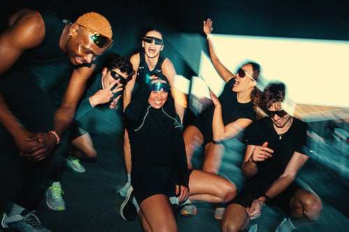 Workout time finds running friends in a playful group pose before the run club session