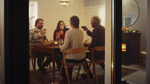 Family toasting wine at Christmas dinner
