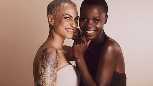 Two beautiful women smiling together