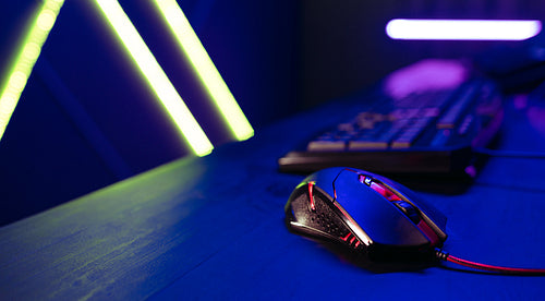 Gaming station: Computer mouse places on a table next to a gamer's pc