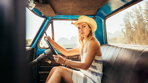 Attractive young woman sitting in a car
