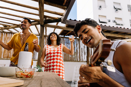 Friends enjoy samba music together with a cavaquinho in Rio de Janeiro