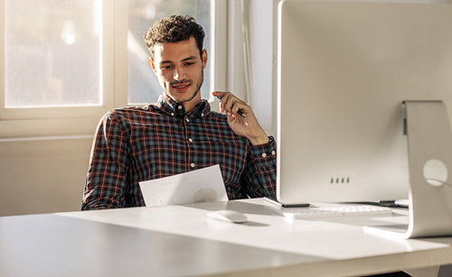 Businessman looking at business papers in office