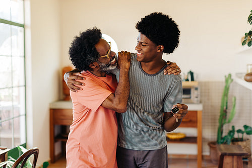 Cheerful father and son: Bonding and smiling together at home