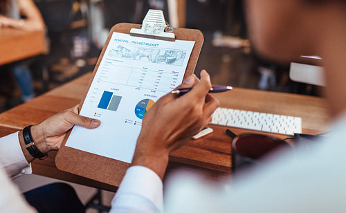 Business people analyzing statistical charts in office