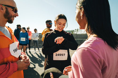 Runners gather at the marathon starting line under clear skies