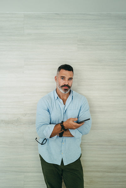 Businessman holding a smartphone in an office