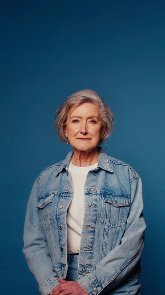 Confident senior woman on blue studio background