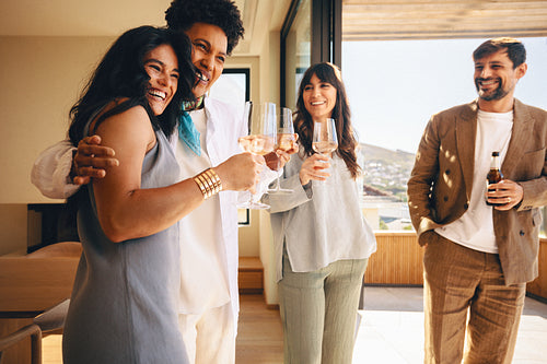 Friends enjoying drinks together in a bright and stylish indoor-outdoor space