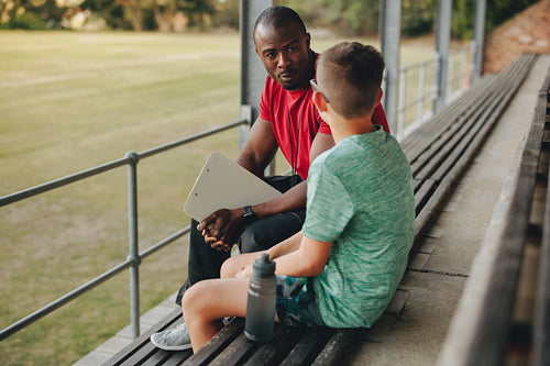 Physical education teacher talking his student outside