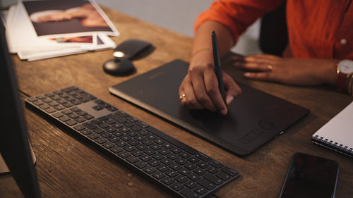 Freelance designer drawing on a graphics tablet