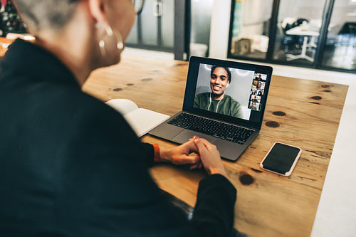 Smart businesswoman attending a virtual meeting in a modern workplace
