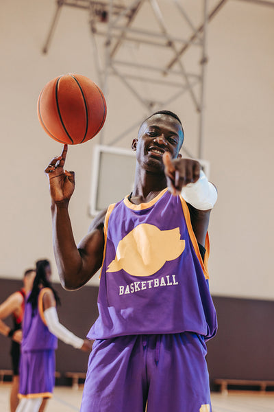 Young basketball player spinning a ball on finger during a game