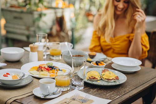 Tourist woman enjoying breakfast at a holiday resort
