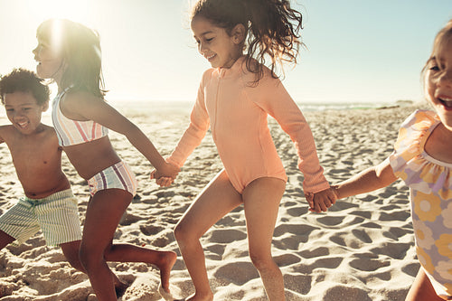 Young friends playing together at the beach