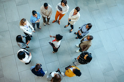 Arial view of female manager instructing a diverse team in office
