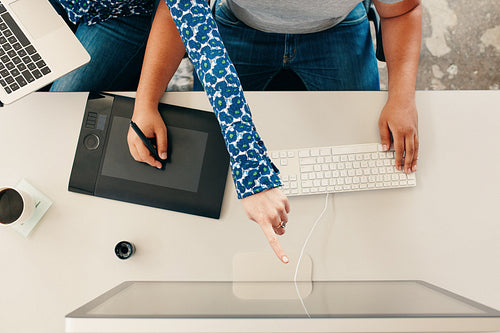 Hands of graphic designers working together