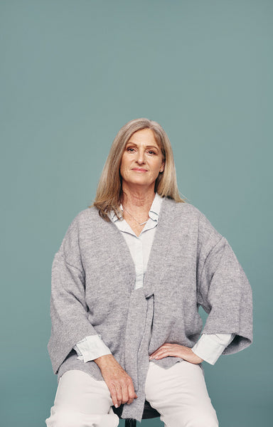Senior woman sitting on a chair in a studio