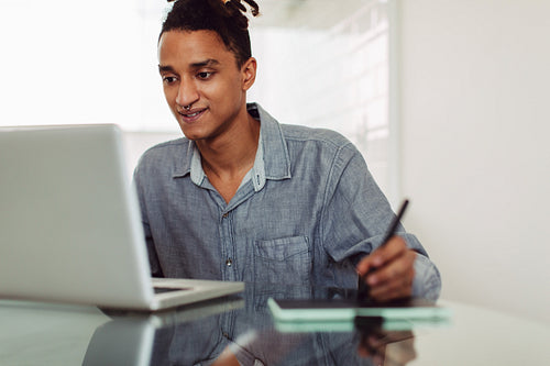 Young businessman attending an online meeting