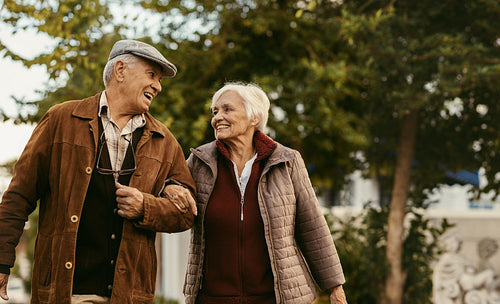 Loving senior couple enjoy a walk together on a winter day