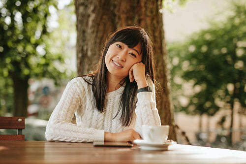 Young woman relaxing at outdoor cafe