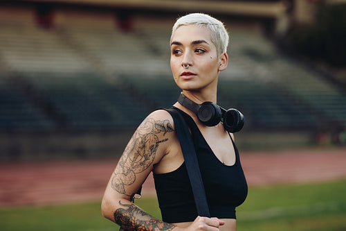 Portrait of a woman runner standing in an athletic stadium