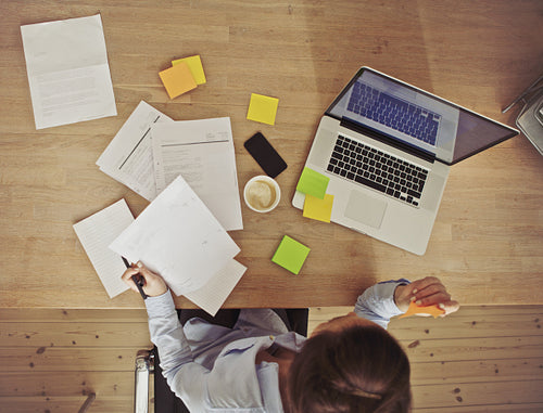 Overhead view of businesswoman working at desk