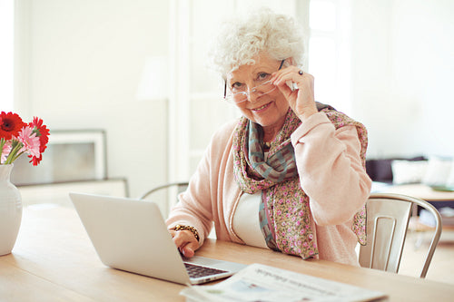 Mature Woman at Home Using Laptop