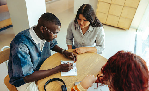 Focused study group collaborating in a modern campus setting, highlighting teamwork and shared learning experiences