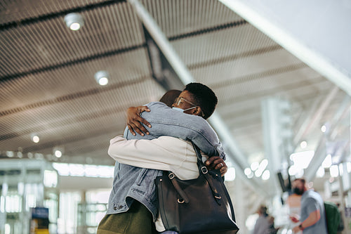 Man and woman giving good bye hug at airport