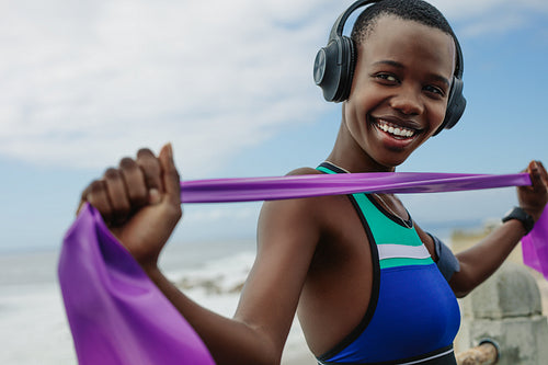 Fit woman exercising with a resistance band outdoors