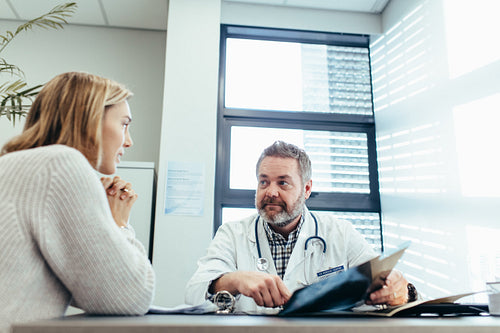 Doctor talking with female patient during consultation