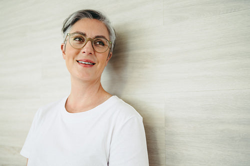 Cheerful businesswoman looking away thoughtfully