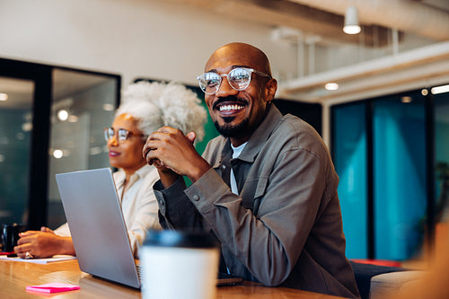 Engaged in the discussion: Coworker listening during team meeting