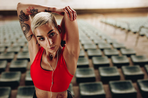 Fitness woman doing workout in the stands of a stadium