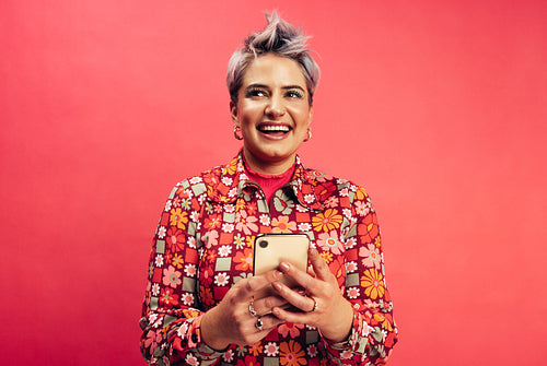 Stylish young woman holding a smartphone