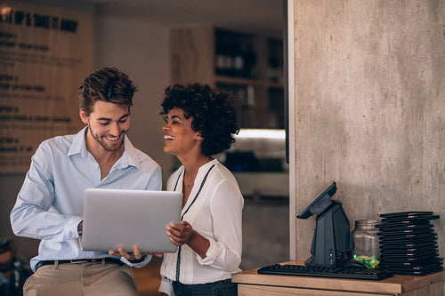 Restaurant partners with laptop computer