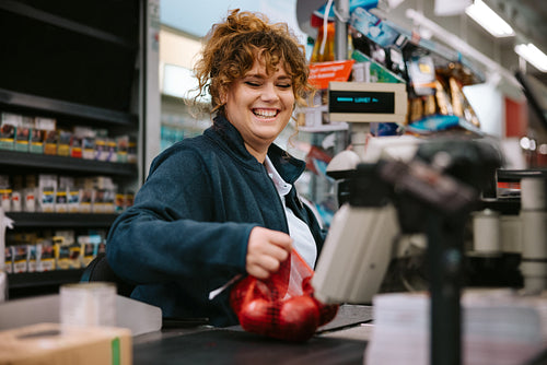 Cashier scanning grocery products at checkout