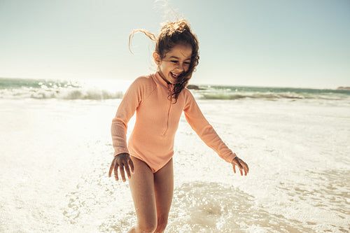 Happy little girl having fun on sea water