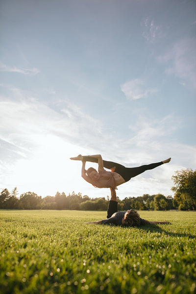 Fit young couple doing acrobatic yoga