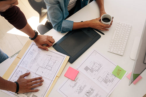 Business partners working on architecture plans in office