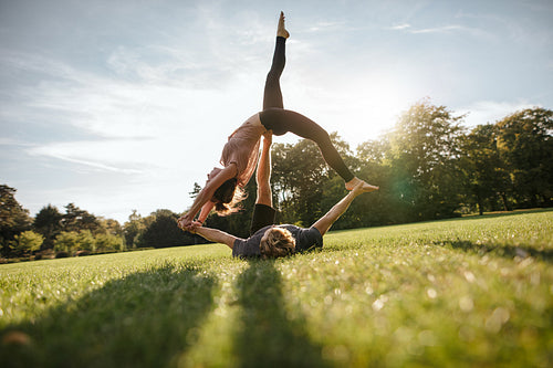 Young man and woman doing yoga in pair