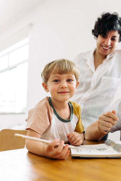 Cute boy learning to write at home