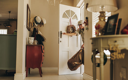 Happy female soldier making a surprise homecoming