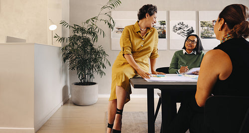 Mature female executive leading a collaborative planning meeting in a modern office