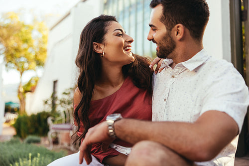Couple laughing together outside a hotel