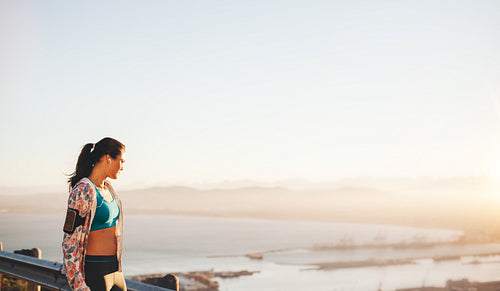 Fit young woman runner standing outdoors