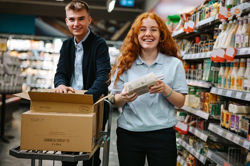 Supermarket employees working in the store